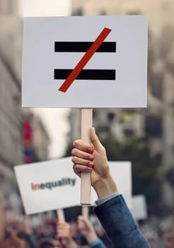 Hands hold banners during protest to stop human inequality as global social issue. Protesters with placards against discrimination on grounds of race, sex or religion. Injustice unfairness symbol