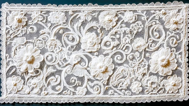 White lace embroidery featuring intricate flowers and swirls creates a delicate design against a dark background, highlighting traditional craftsmanship in textile art