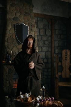 Thoughtful medieval monk standing in cathedral. Religion and faith concept