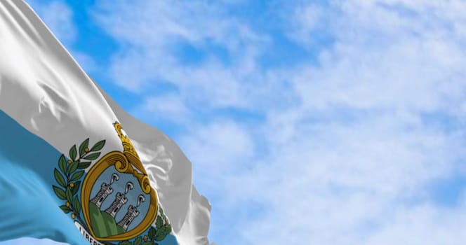 Flag of San Marino waving in the wind on a clear day. European microstate. 3d illustration render. Fluttering fabric. Selective focus