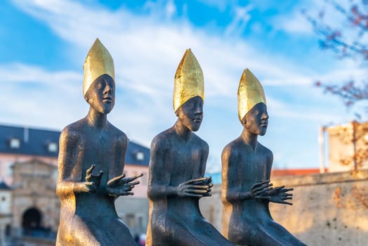 ERFURT, GERMANY - NOVEMBER 30, 2024: Three bishop sculptures in front of the Citadel of Petersberg, one of the largest and best-preserved town fortresses in Europe. The citadel was built on Petersberg hill, in the north-western part of the old town centre.