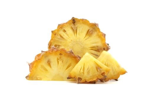 Close-up view of juicy pineapple slices arranged on a clean white backdrop showcasing their tropical and fresh characteristics. Golden yellow color accentuates the fruit’s natural sweetness and appeal
