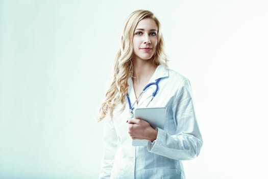 Confident doctor stands holding a digital tablet, symbolizing the integration of technology and healthcare, improving diagnoses, treatments, and patient care