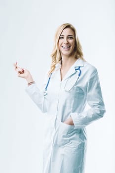 Young female doctor smiling and showing something, imagining the future of medicine with artificial intelligence and automation improving healthcare