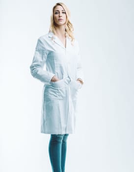 Young female doctor or scientist standing confidently with hands in pockets, embodying the fusion of artificial intelligence and automation in healthcare innovation