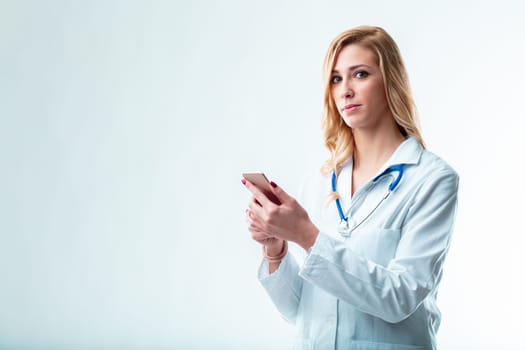 Young female doctor in copyspace, with a tablet for telemedicine, patient data control, national healthcare system updates