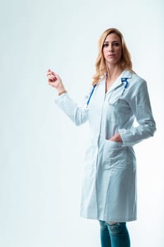 oung blonde doctor points to a copyspace for your item. Potentially a dentist, gynecologist or any medical specialist