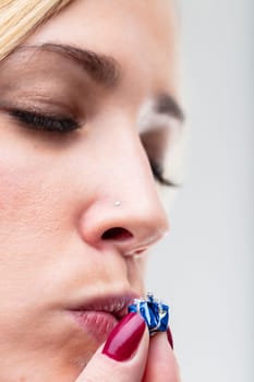 Tiny beloved gift gets a kiss from a blurred woman in the background. The thought behind the gift is important to her