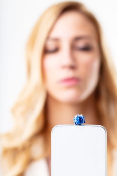 Blonde woman enjoying online shopping via smartphone, credit card, and gift. Quick and comfortable through internet and digital domain