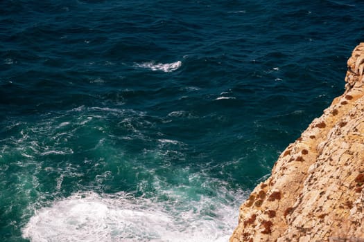 Rocky landscape. Scenic view of sea and Portugal Algarve Cliffs. A beautiful coastline with rocky shore and yellow rocks. Travel destination.