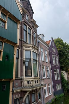 Colorful house facades on a water canal in the old town of Alkmaar in the Netherlands