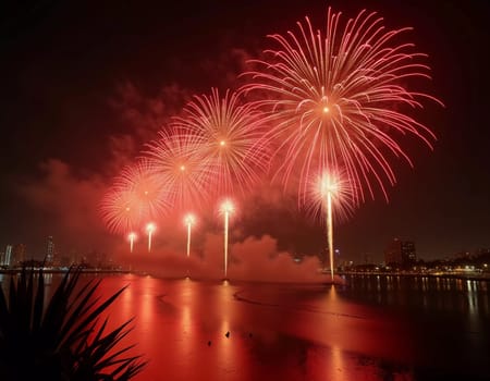 Brilliant red and gold fireworks explode against the dark sky, reflecting in the waterway. The celebration lights up the city skyline during a festive nighttime event. Generative AI.