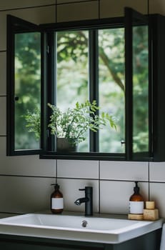 A modern bathroom features a window with lush greenery visible outside, adding a natural touch to the sleek design.