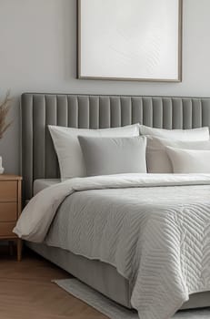 A stylish bedroom features a tufted gray headboard, layered bedding, and neutral tones, creating a serene and inviting atmosphere.