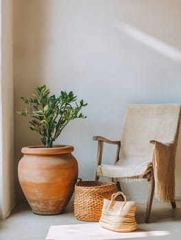 A warm and inviting indoor space featuring a terracotta pot with a leafy plant beside a woven chair and decorative baskets on the floor.
