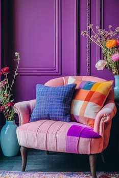 A stylish seating area featuring a pink chair with colorful cushions, surrounded by vibrant flowers and purple walls.