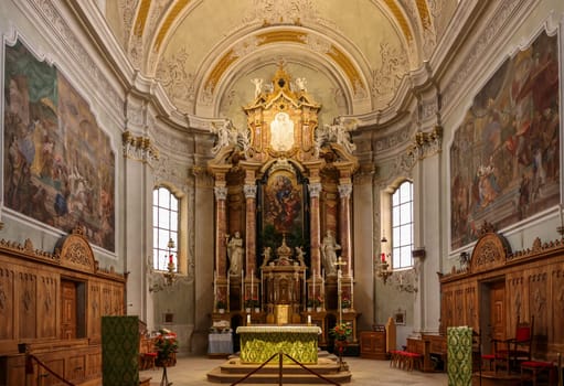 Cortina d'Ampezzo, Italy - September 6, 2024: Main altar of Basilica Parrocchiale SS. Filippo e Giacomo in Cortina d'Ampezzo, Province of Belluno, Veneto, Italy