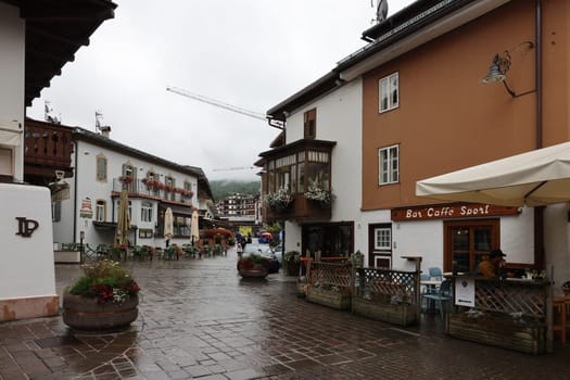 Cortina d'Ampezzo, Italy - September 6, 2024: Corso Italia -  Pedestrian Zone and Main Street in the Center of Cortina d Ampezzo, a Famous Skiing Resort in the Dolomites