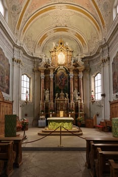 Cortina d'Ampezzo, Italy - September 6, 2024: Main altar of Basilica Parrocchiale SS. Filippo e Giacomo in Cortina d'Ampezzo, Province of Belluno, Veneto, Italy