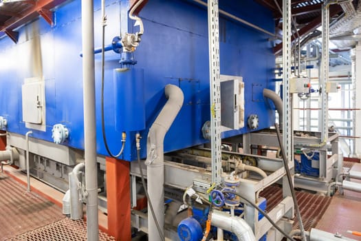Modern industrial steam boiler room equiped for heating process.