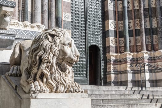 Genoa, Italy - 28 December 2023: the guard lion at the entrance of the Duomo - most important church of the town