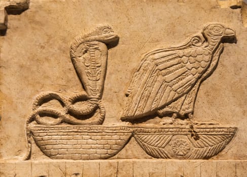 Turin, Italy - 28 December 2023: Egyptian Museum. Plaque with vulture and cobra, limestone, 400 BC