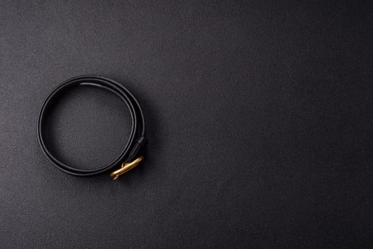 New leather women's belt with an old-style metal buckle on a dark concrete background