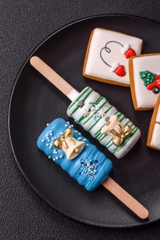 Natural popsicle ice cream on a stick covered with chocolate in the style and colors of Christmas and New Year on a dark concrete background