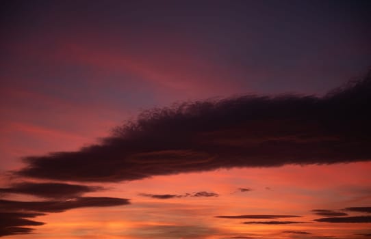 Sunset Sky Aglow with Radiant Clouds.The sunset sky is aglow with radiant clouds painted in hues of orange, yellow, and magenta, casting a spellbinding and captivating scene