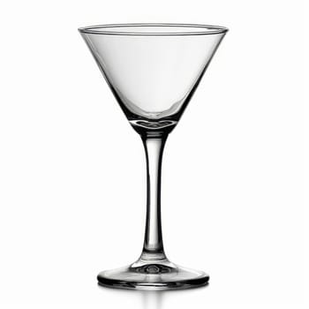 A tall, clear martini glass stands elegantly on a shiny surface. Its delicate design enhances the aesthetic of classic cocktails, perfect for upscale gatherings or casual moments.
