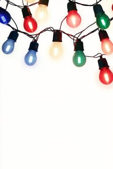 Vibrant string lights in various colors on a white backdrop, perfect for festive and celebratory themes.