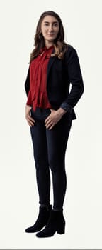 Full-body portrait of a confident young businesswoman standing with her hands on her hips, exuding professionalism and determination against a clean white background