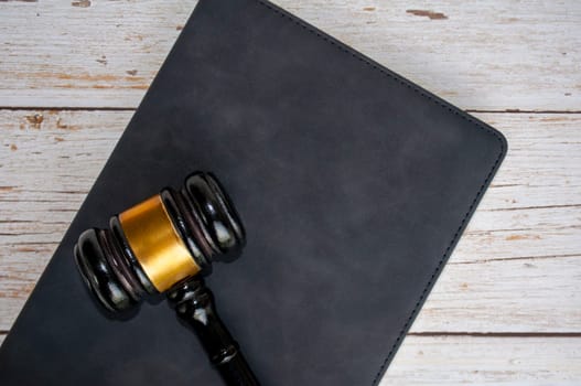 Top view of gavel on top of black cover book. Laws and Regulations concept.