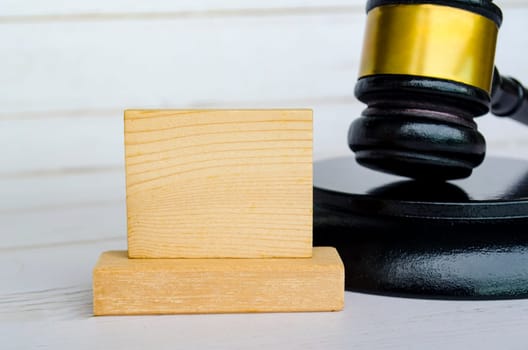 Empty wooden square with customizable space for text with gavel background.