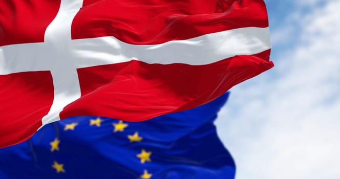 National flag of Denmark and of the European Union flag waving in the wind. 3D rendered illustration. Selective focus. Fluttering fabric. EU membership