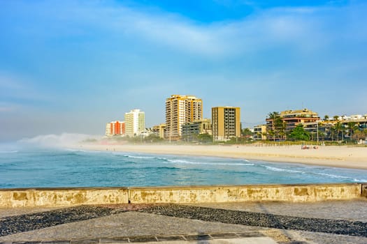 Morning on the breakwater of Barra da Tijuca beach, one of the most famous in the city of Rio de Janeiro with its buildings facing the sea