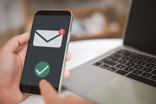 A person is holding a cell phone and checking email, Person is likely checking the email, New email notification concept for business email communication, Electronic message notifications.