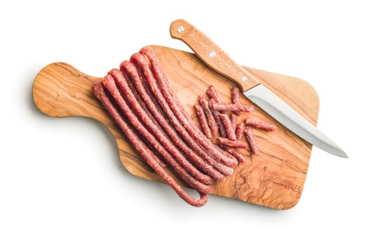 Smoked kabanos. Mini dried thin sausages on a cutting board isolated on white background