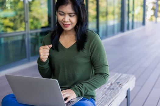 Business woman working from coffee shop using laptop online meeting in home office, Business woman typing keyboard use notebook laptop Smiling, laughing at coffee shop relaxation table.