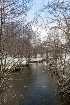 Winter landscape on a small river with snow