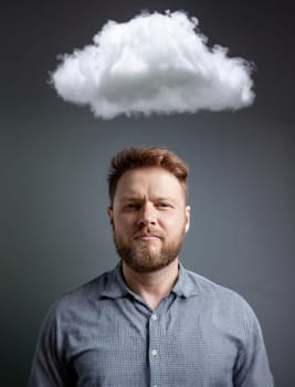 Man with a storm cloud hovering above his head. Concept of losing memory. Cloudy and moody thoughts