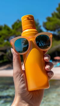 A bright orange sunscreen bottle is held against a backdrop of lush, tropical greenery, with a pair of stylish sunglasses reflecting the idyllic scene