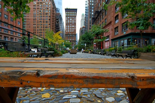A tranquil public plaza nestled amidst the towering skyscrapers of a bustling city, offering a peaceful respite with lush greenery, benches, and pedestrian pathways.