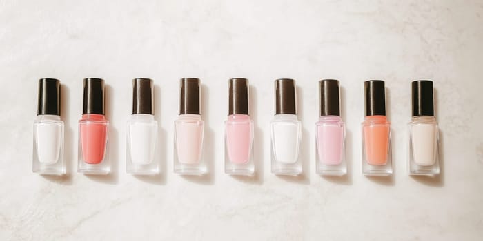 Nail polish bottles of neutral colors arranged on a marble background, AI Generated
