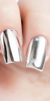 Metallic silver chrome nails closeup with rhinestone accents, vertical background, AI Generated