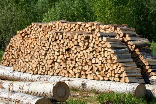 a large supply of chopped wood laid in a fire. High quality photo