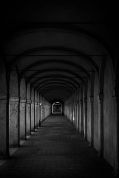 Dark tunnel perspective. Grunge architecture, old corridor in shadow
