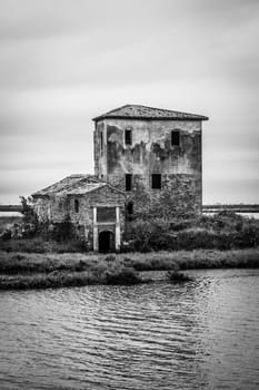 Abandoned building in front of a lagoon. Creepy construction exterior, no people
