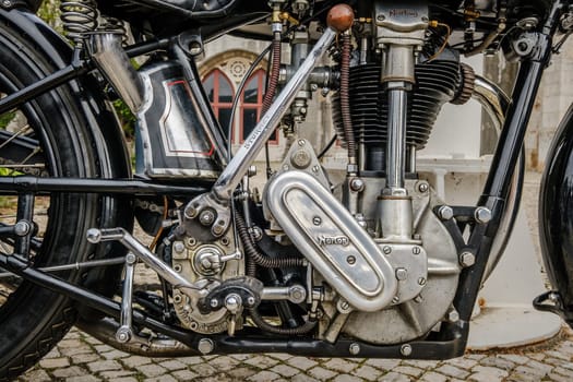 Lisbon, Portugal - Oct 15, 2023: Close-up of engine area of iconic Norton ES2 motorcycle by Norton Motors Ltd, Aston, Birmingham, parked on cobblestone road. Reliable and very popular long stroke single of traditional design.