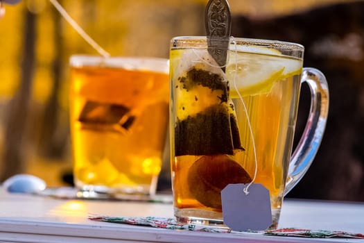 Transparent mug with tea. Brewing tea in a bag.